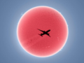 Efektowne ujęcie samolotu na tle tarczy słonecznej